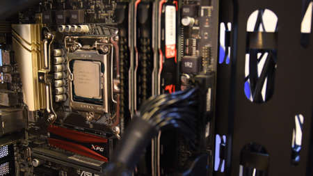 Selective focus inside PC tower with motherboard mini-ITX and CPU Intel Core i7 Processor, NVME SSD, microcircuits and connected cables. Computer hardware installation. Odessa, Ukraine, 03 19 2021のeditorial素材