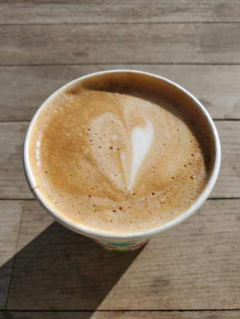 Double espresso with whipped milk foam. Coffee drink called Flat White. Coffee to go in takeaway...