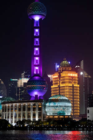 Famous Shanghai tower and sphere shaped architecture of buildings with colorful neon lights. Night cityscape of Shanghai China view from Bund Waitan waterfront. Shanghai, China, Lujiazui 12 04 2019のeditorial素材