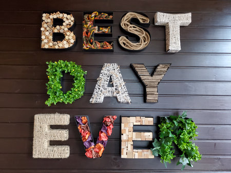3D shaped letters on wall. Craft letters made of various textures such as woods, rope, fabric, twine, leaves, flowers. Wishing quote - Best Day Ever. Interior decorationの写真素材