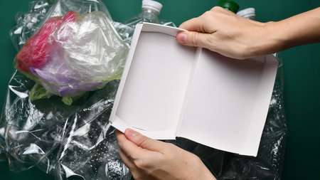 Female hands tear cardboard box before sorting waste for recycling. POV preparation of trash....