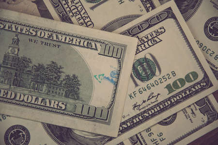 Flat lay American cash banknotes 100 dollar bills marked by inked symbols. Blue ink strange symbols stamped on banknote. Cash US dollar money backgroundの写真素材