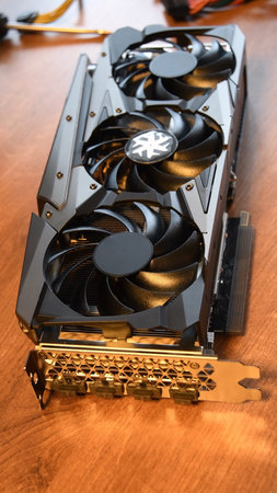 Brand new graphics card for gaming PC and cryptocurrency mining. Three black fans of video card...