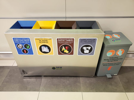 Separate trash bins for recyclable types of garbage and trash can for used face masks and disposable...
