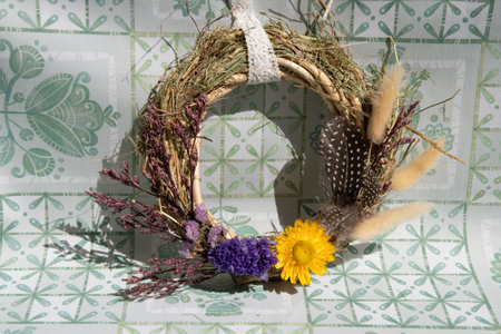 Delicate wreath features an array of dried flowers, herbs, and grasses, showcasing natural beauty.の写真素材