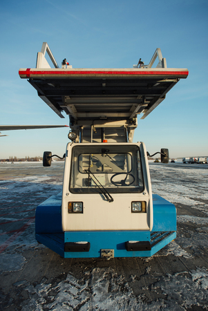 Boryspil, Ukraine - December 07, 2016; Service ladder car on the airfield of airport near the plane ready to transportation. Front viewのeditorial素材
