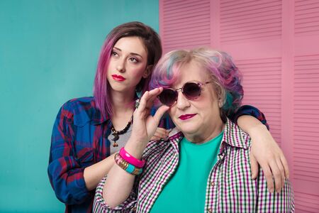 Contemporary parents and children who express themselves with bright clothes and stylish hair. Communication of generations.の写真素材