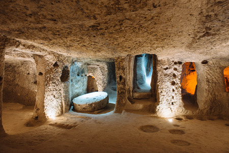 The Derinkuyu underground city is an ancient multi-level cave city in Cappadocia, Turkey. Stone used as a door in the old underground cityの写真素材