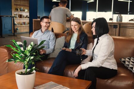 Business discussion of freelancers in co-working. Team working in relaxed, informal atmosphere of officeの写真素材