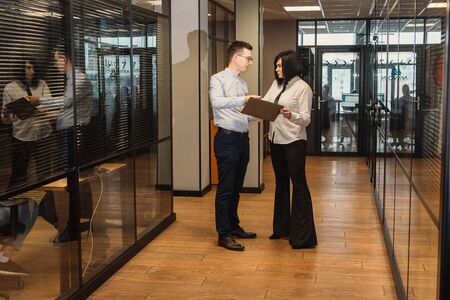 Business People In Office Going To Work in modern office. Corridor greetings of collegesの写真素材