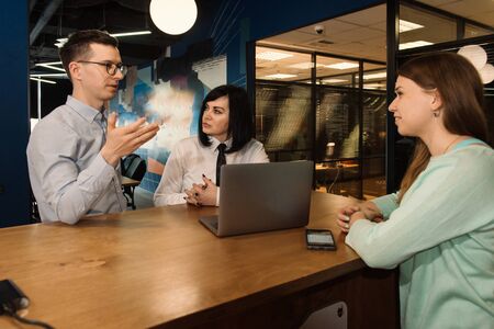 Discussion of young businessman and company staff in modern office with client. Insurance or investment decisionの写真素材