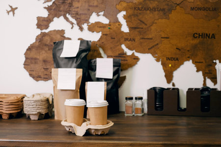 Disposable paper cups with coffee for takeaway food. Packages with coffee on counter for...