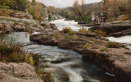 Long exposure image of beautiful stream of water running through cascades of rocks and stones.