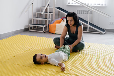 Rehabilitation of children with cerebral palsy. Physical activities for disabled kids in center....