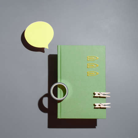 Notepad, yellow sticker and office supplies on the blue background. Mock up in copy space office background.の写真素材