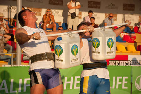 Kiev, Ukraine, 08.13.2017 Strongmen athletes training on carrying a large weight, heavy barbellのeditorial素材