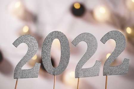 2022 number in sparkling silver over lights bokeh celebrating New Year Party Celebration