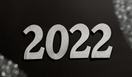 2022 number in sparkling silver over black background, celebrating New Year bannerの写真素材