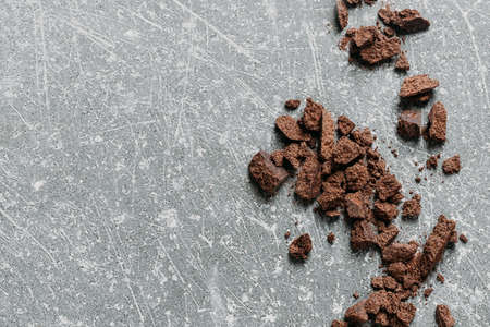 Chocolate crumbs in bowl ready for cooking top view. Organic fermented or raw cacao beans for hot drinks. Flat lay with copy space for recipe. Ingredients for sweet foodの写真素材