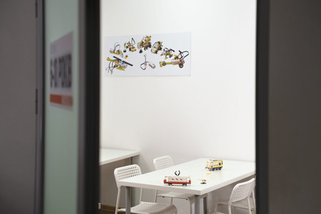 Empty class in school after science lessons. Tables in the room with handmade toys, nobody. Copy...