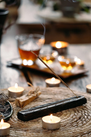 Burning aroma stick incense. Relaxing, stress relief, meditation smoke, refreshing, sensuality energizing Incense for aromatherapy with candleの写真素材