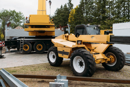 Construction crane lifting heavy freight. Modern mobile transportation technologies help building...