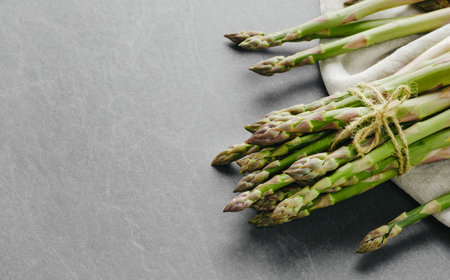 Asparagus on dark background, top view. Copy space. Fresh healthy vegetableの写真素材