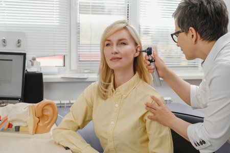 Woman patient having check-up of hearing at doctor otolaryngologist. Hearing exam for female....