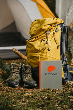 Digital detox while traveling, accessories for hiking in the mountains and book with brain. Unplugging from Technology and reconnect with nature conceptの写真素材