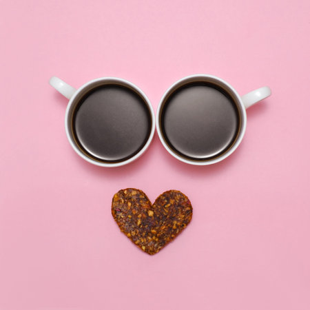Coffee creative love emoji. Smile from two cups of black espresso and healthy raw heart shaped...