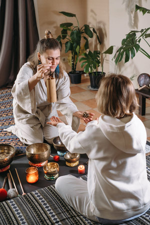 Sound healing with singing bowls, vibration massage and alternative therapy. Mental health care in...