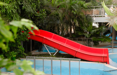 Aquapark with water rides. Indoor water park for entertainment. Nobody. Water slides under roof with...