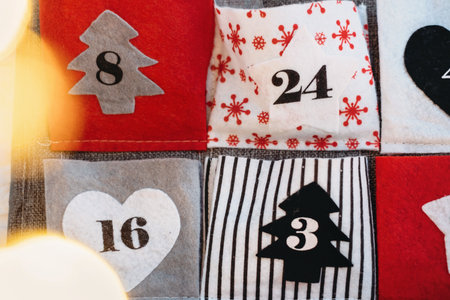 Christmas advent calendar for kids, creative tasks in felt pockets for everyday. 24 handmade numbered bags with gifts. Countdown to Christmas Eve. Close-upの写真素材