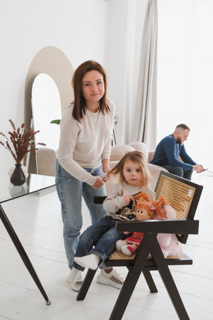 Portrait Mother of with toddler girl ant home. Child and parent portrait in Scandinavian houseの写真素材