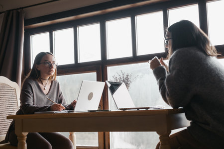 Two adult student study on-line at homeの写真素材