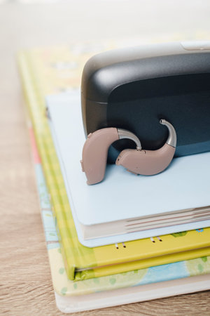 Kids hearing aids on a colorful school desk