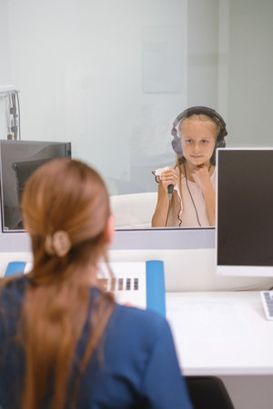 Audiometry hearing test with child in clinic with woman doctorの写真素材