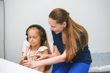 Child hearing test with audiometry headphones in clinicの写真素材