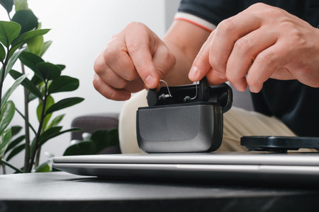 hearing aids on man hand in working environment