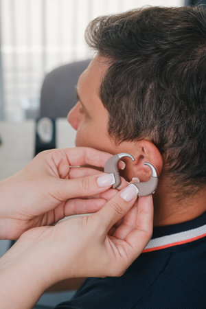 Man selecting modern compact hearing aidsの写真素材