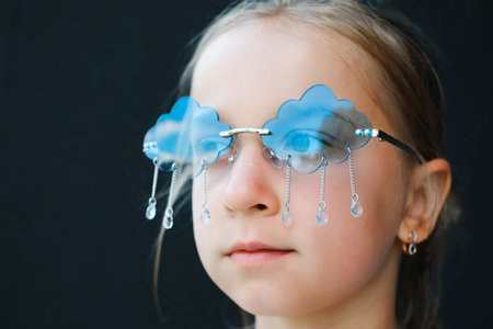 Young girl wearing creative blue cloud sunglasses with rain drops