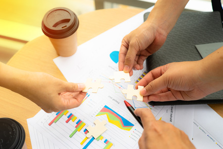 Group of business man holding jigsaw to build a success teamworkの写真素材