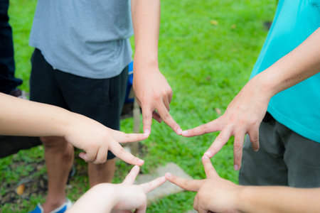 hands and fingers join together as victory star for strong team work to success