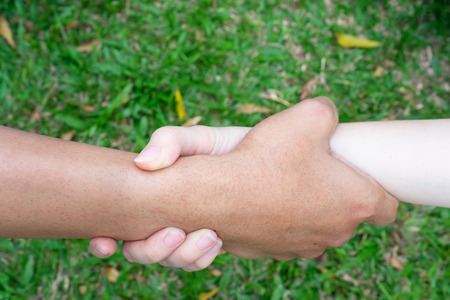 A couple hold hand to help each other and to be togetherの写真素材