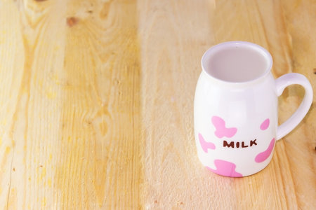Glass of milk on a wooden floor
