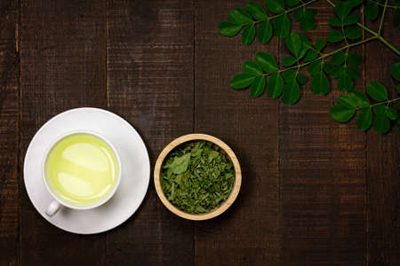 Moringa Tea on wooden background. Moringa oleifera tropical herb healthy lifestyle concept.の写真素材