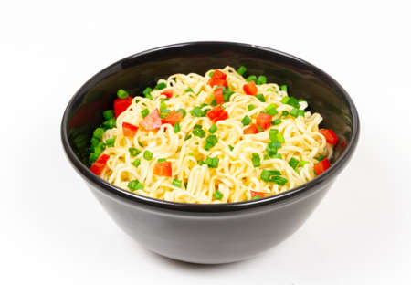Instant noodles in black ceramic bowl isolated on white background.の写真素材