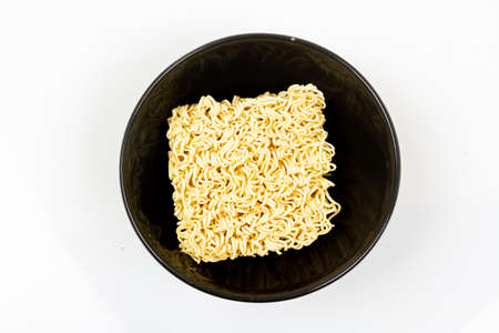 Top view of Instant noodles in black bowl isolated on white background.の写真素材