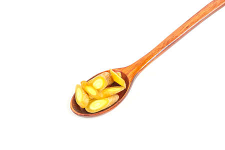 Finger root (Krachai) fresh sliced on wooden spoon isolated on white background. Finger root is herb and Thai food ingredient.の写真素材