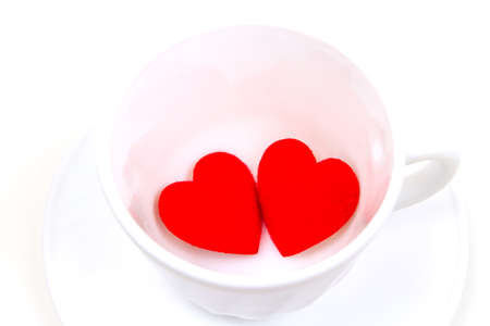 Red heart in white cup ceramic isolated on white background. valentine's day concept.の写真素材